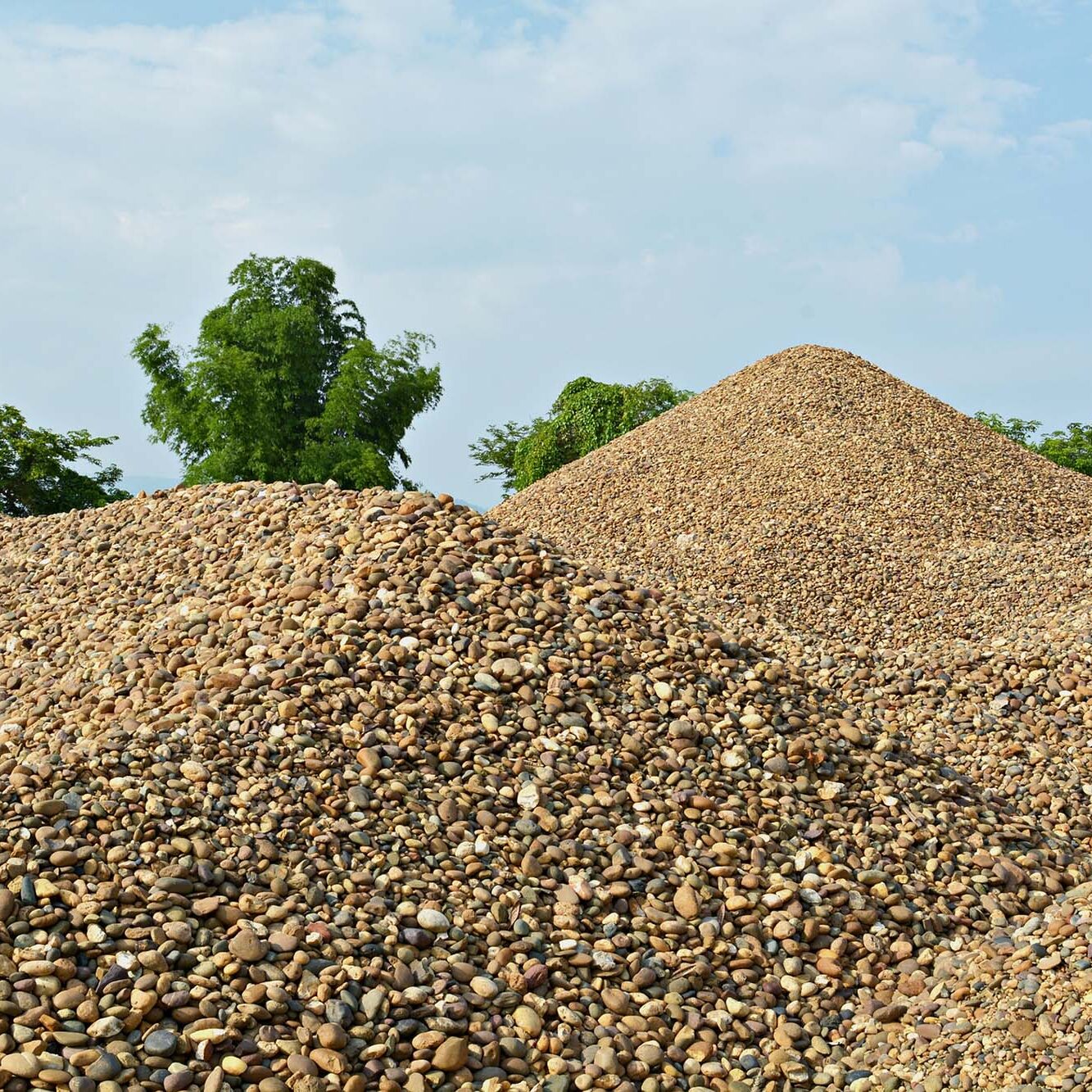 The river gravel pile is sold for cement use in construction.